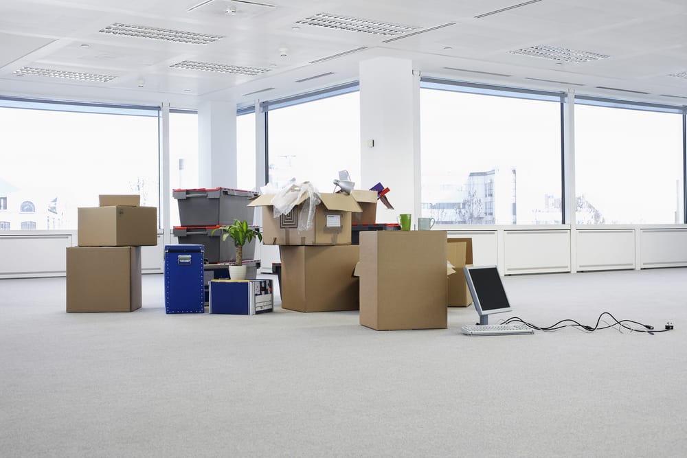 cardboard boxes and computer equipment boxed up for move